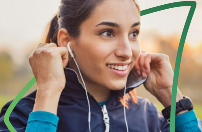 Smiling woman about to put earphones in
